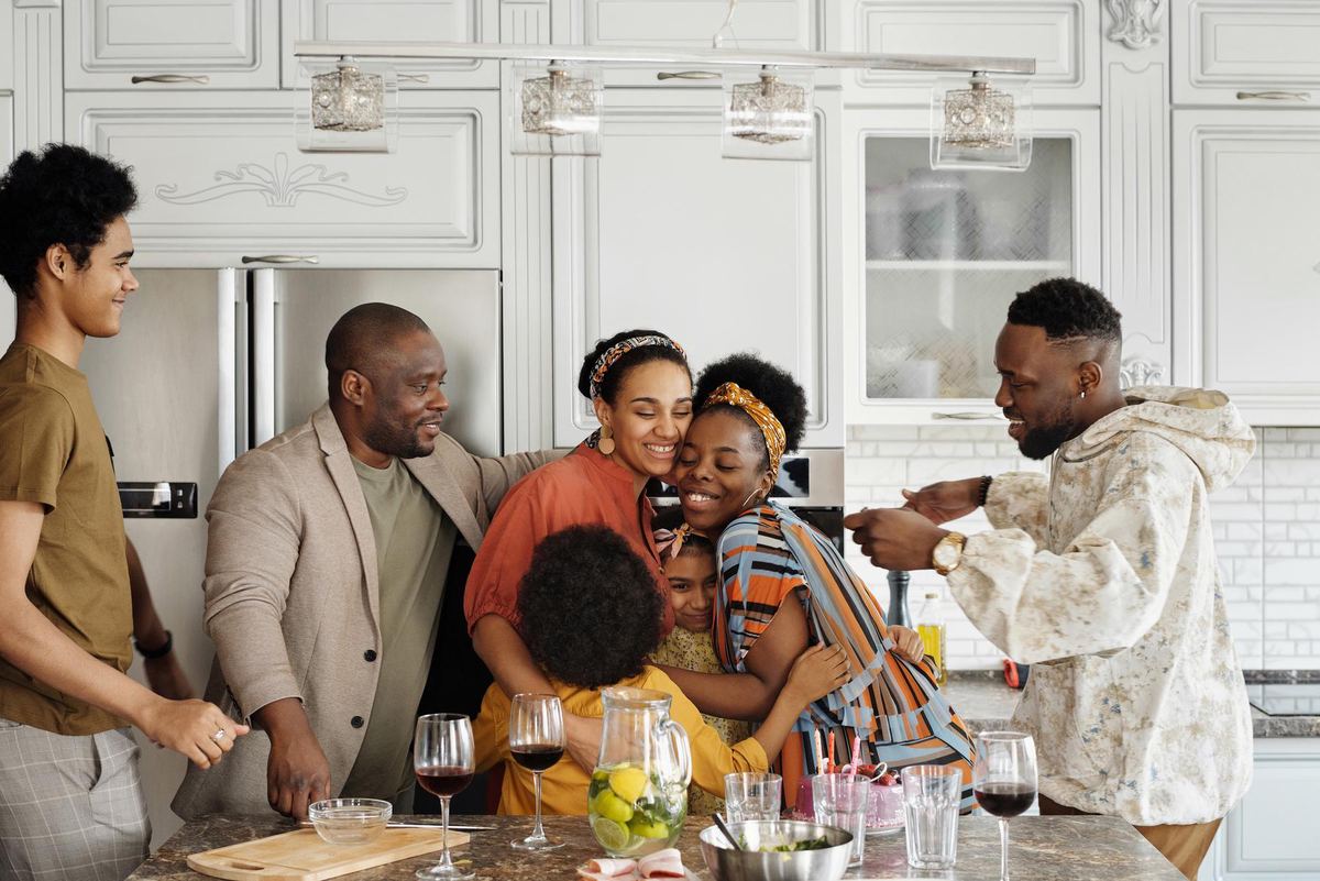 A family laughing together in their kitchen